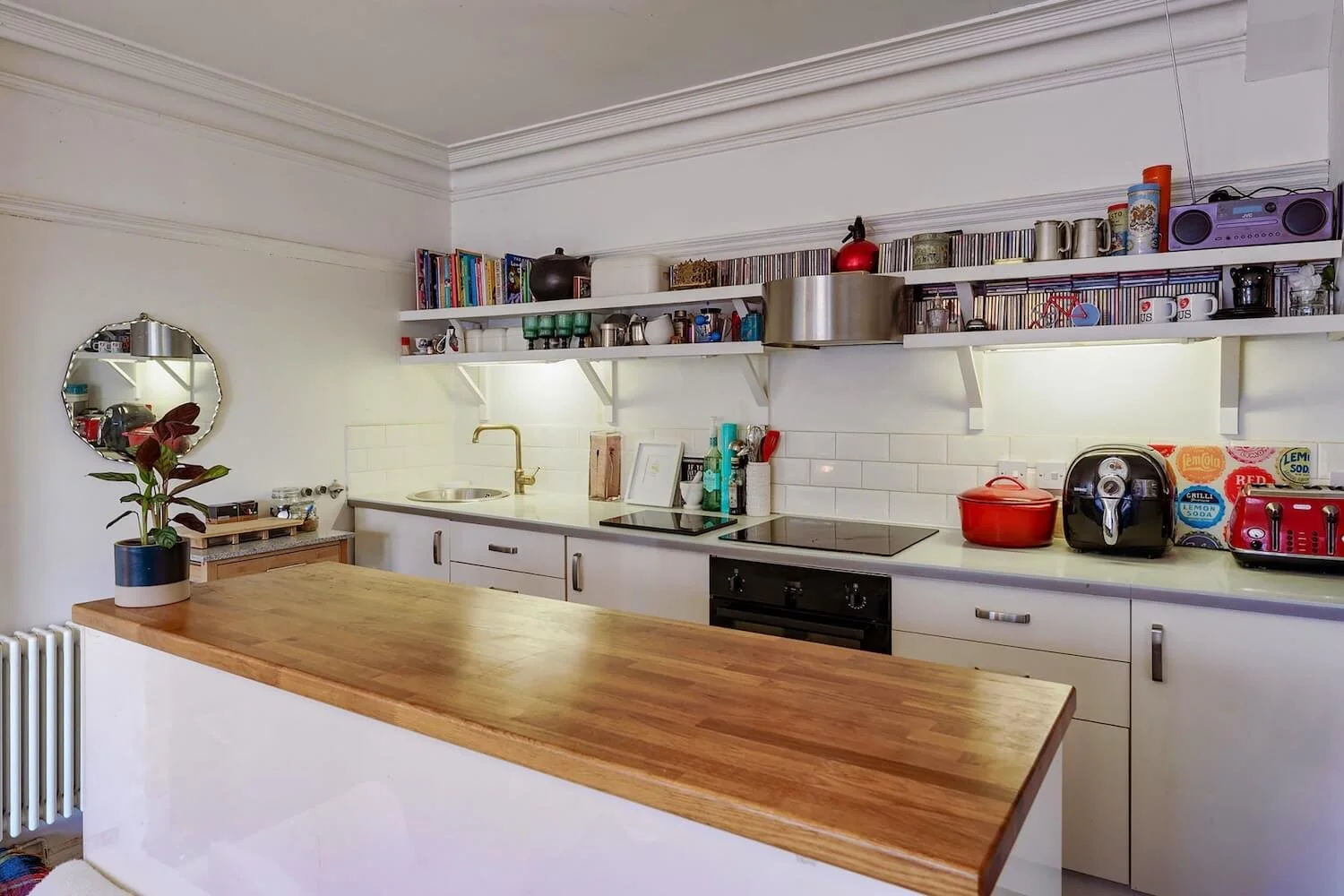 White kitchen with open shelving and wooden countertop