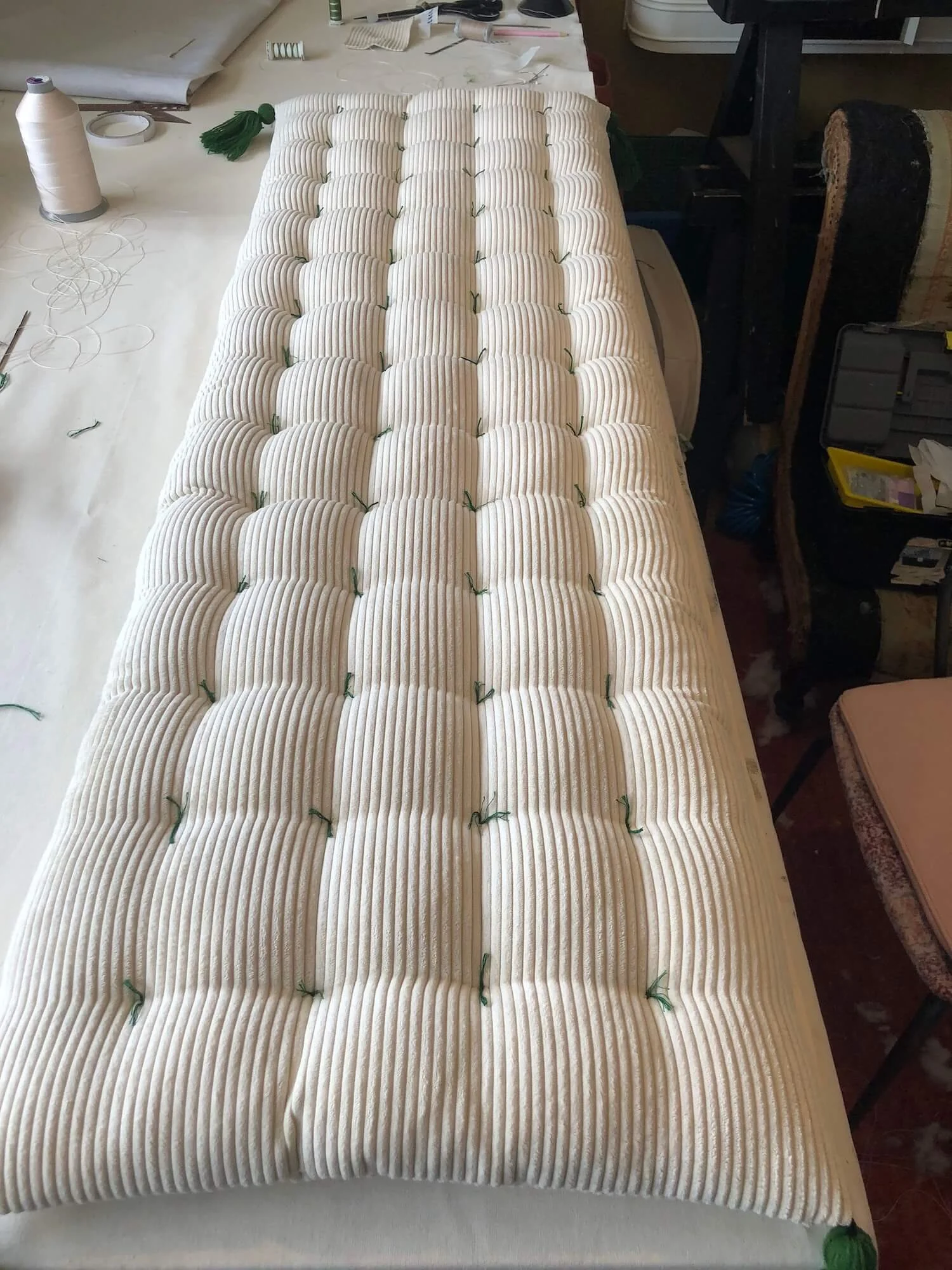 Tufted bench cushion in striped fabric with hand-stitched detail
