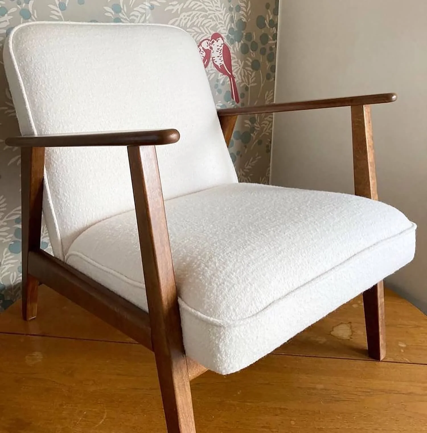 Contemporary armchair with textured linen upholstery and wooden legs