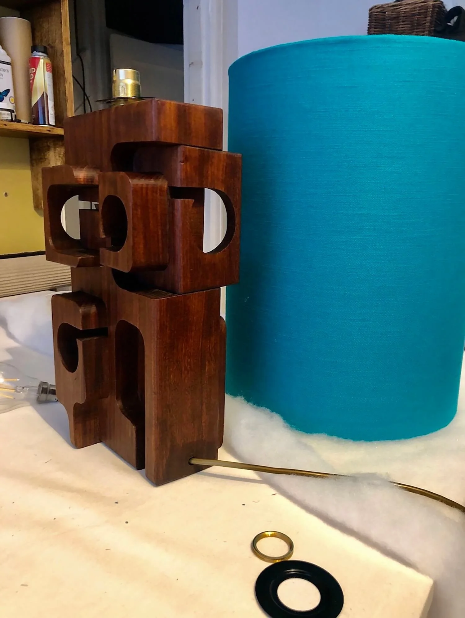 Bright blue fabric lampshade and wooden sculptural base