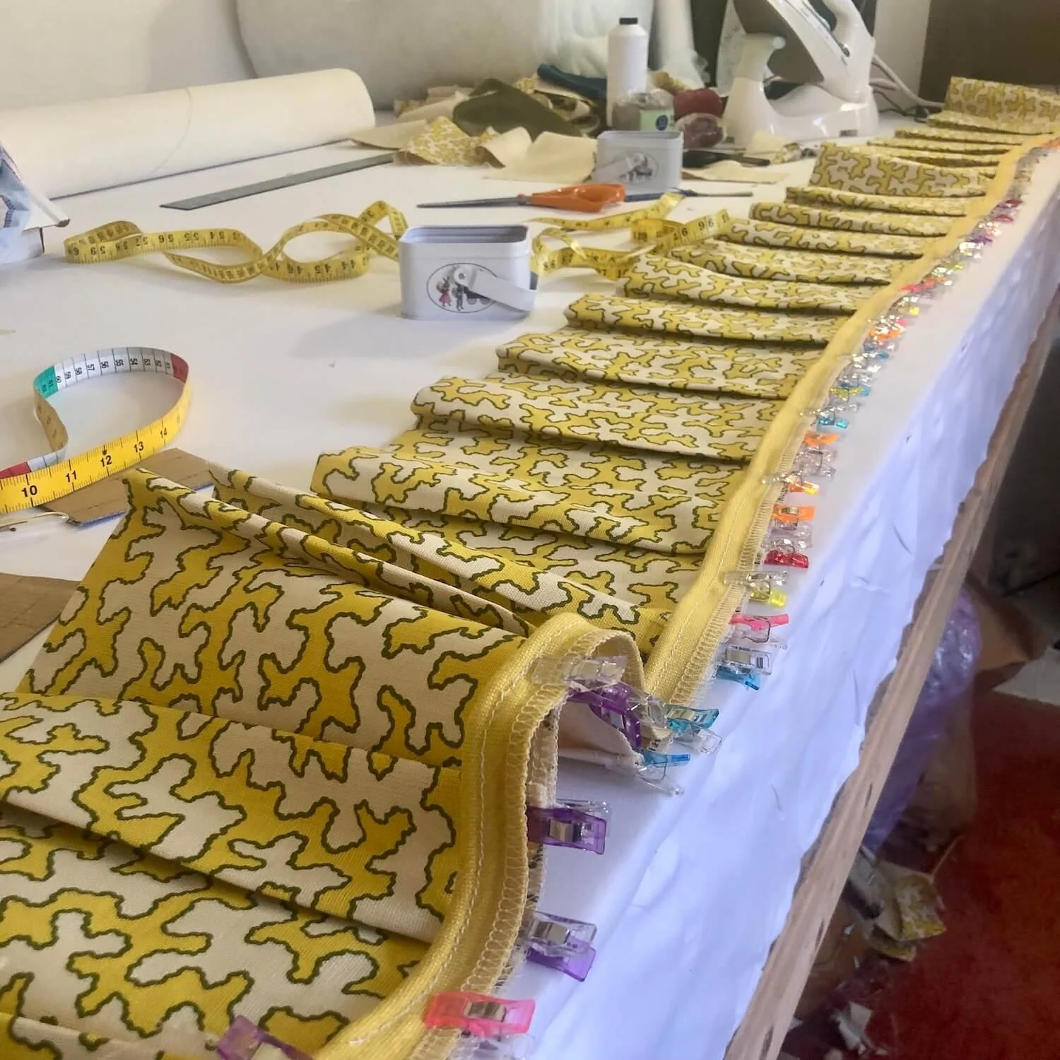 Yellow patterned box cushions and trims prepared for upholstery