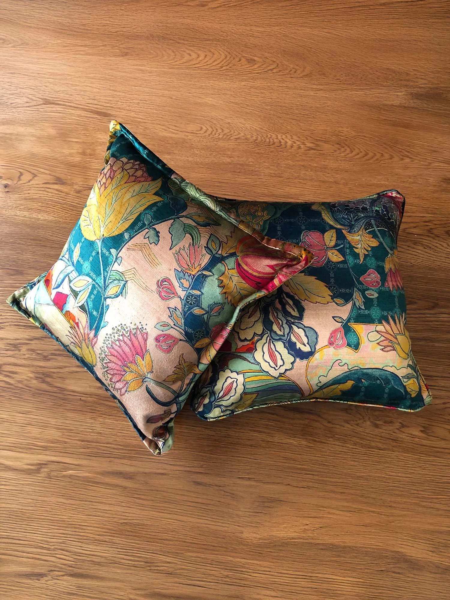 Pair of cushions in Mansfield Park Hartfield fabric styled on wooden surface