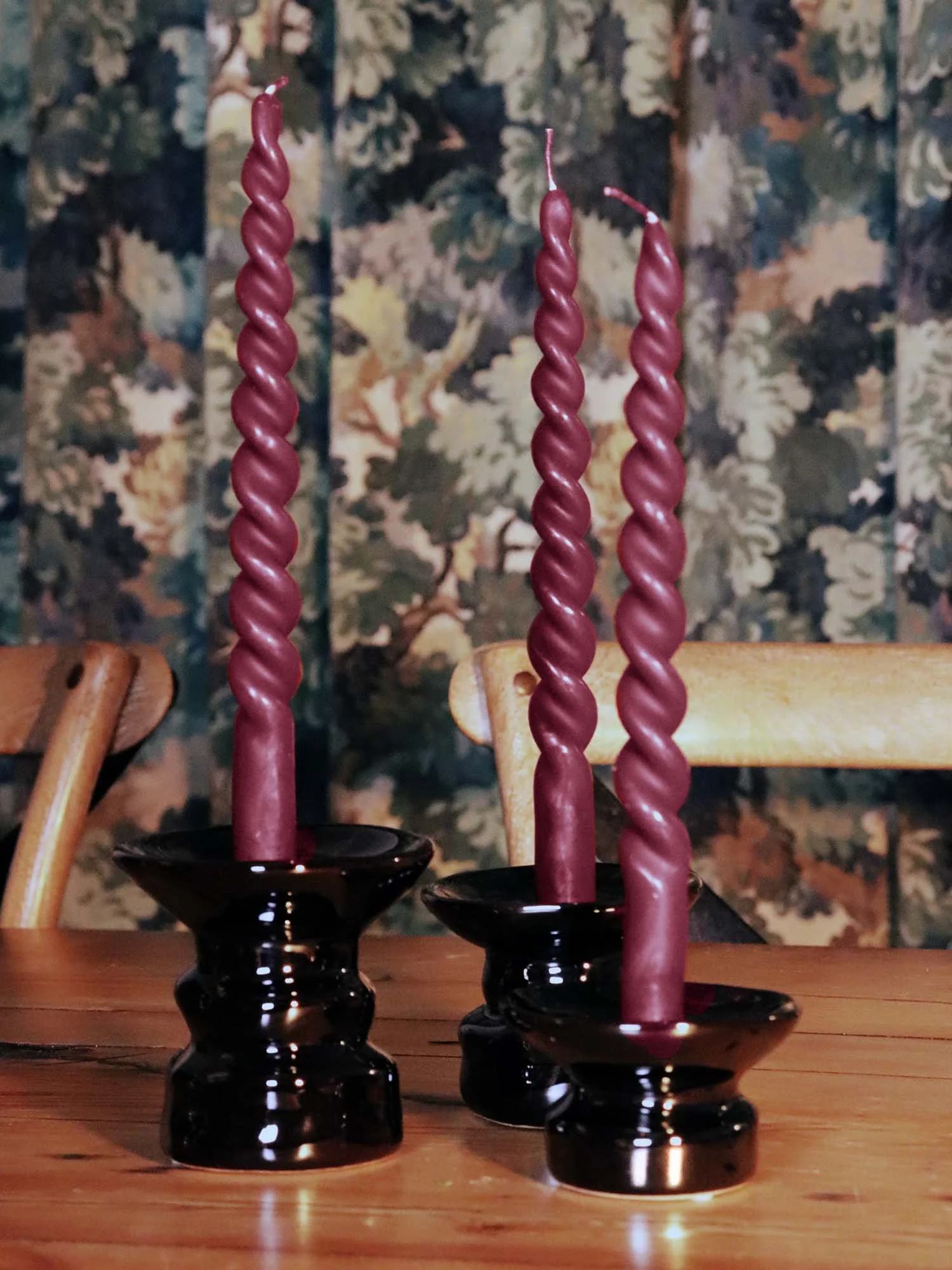 Set of black Padre candle holders with burgundy twisted candles