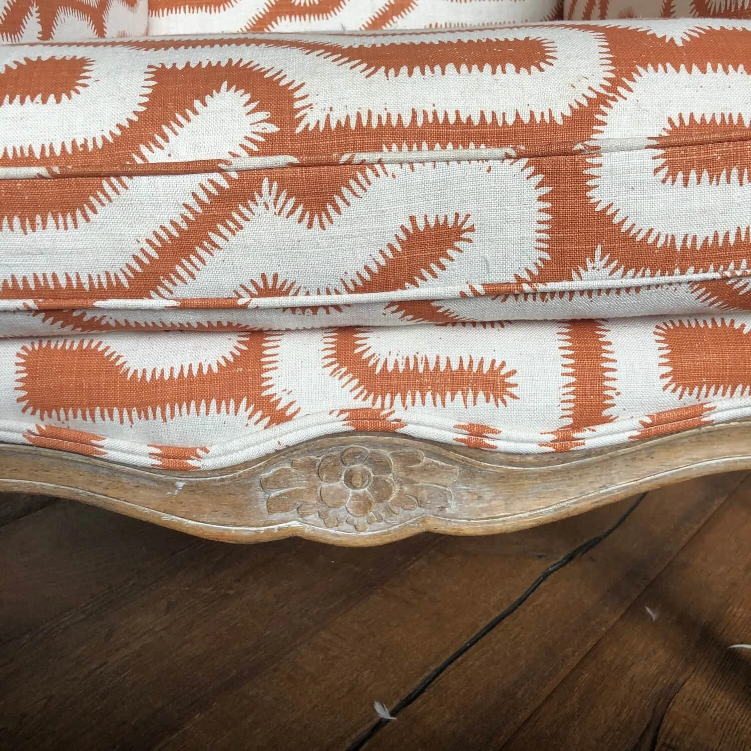 Close-up of traditional hand-stitched upholstery with patterned fabric