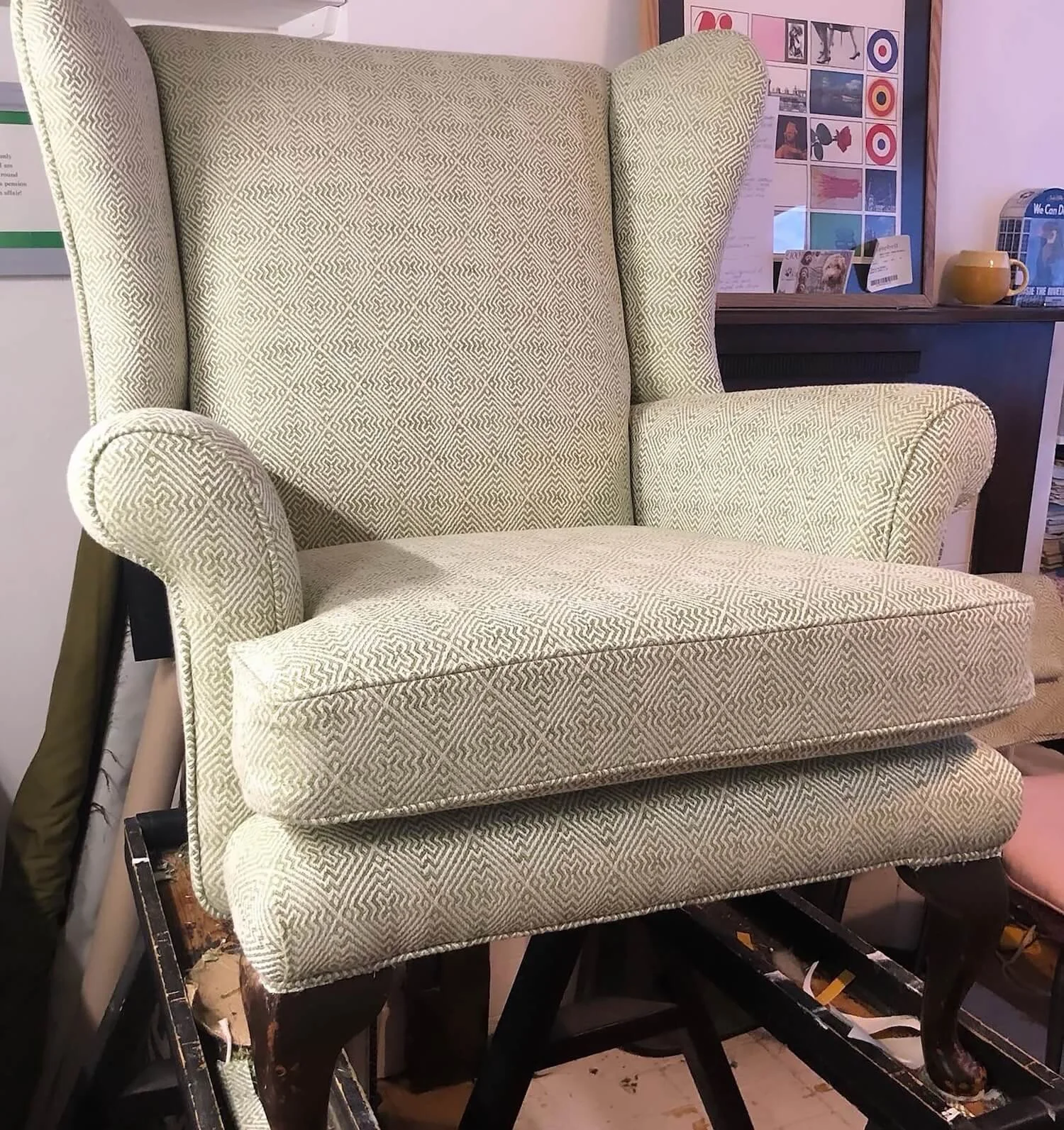High backed chair upholstered in grey woven fabric