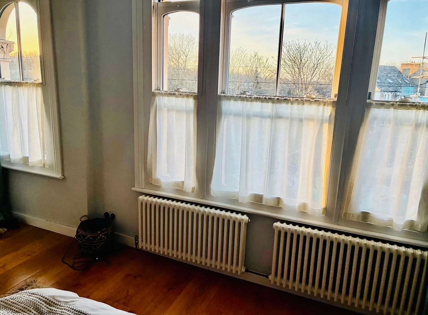 Muslin cafe curtains displayed in large window