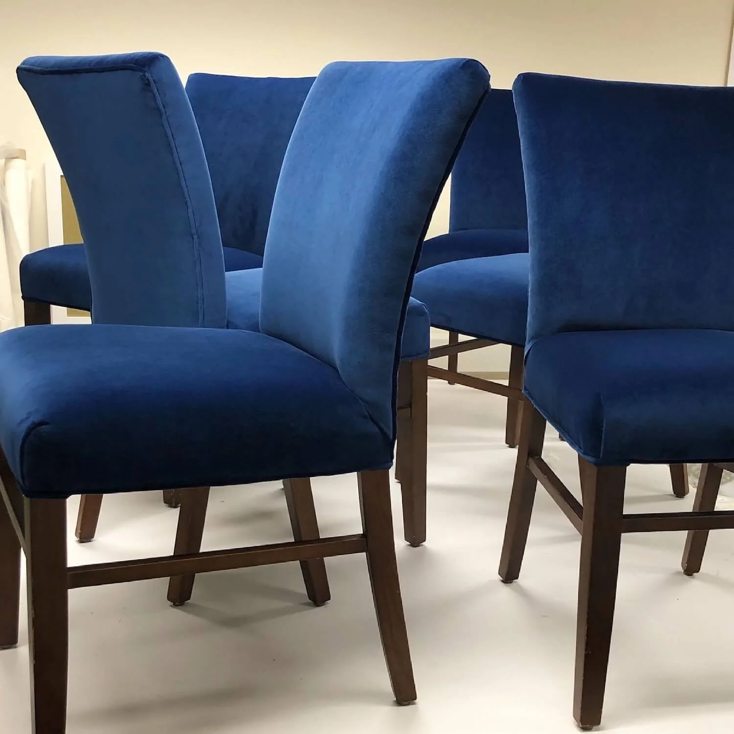 Set of blue dining chairs reupholstered in deep navy fabric