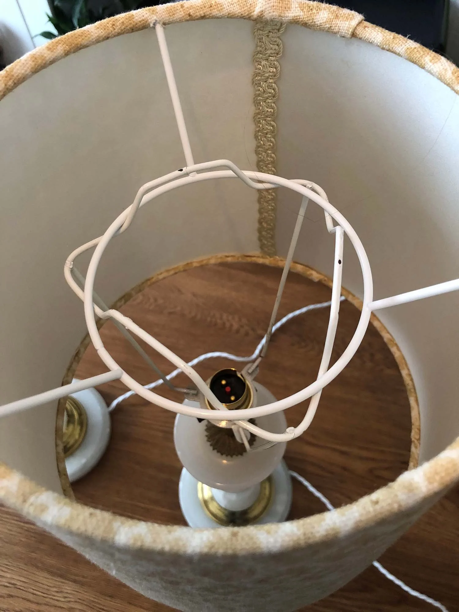 Inside view of lampshade showing wire frame and stitched trim