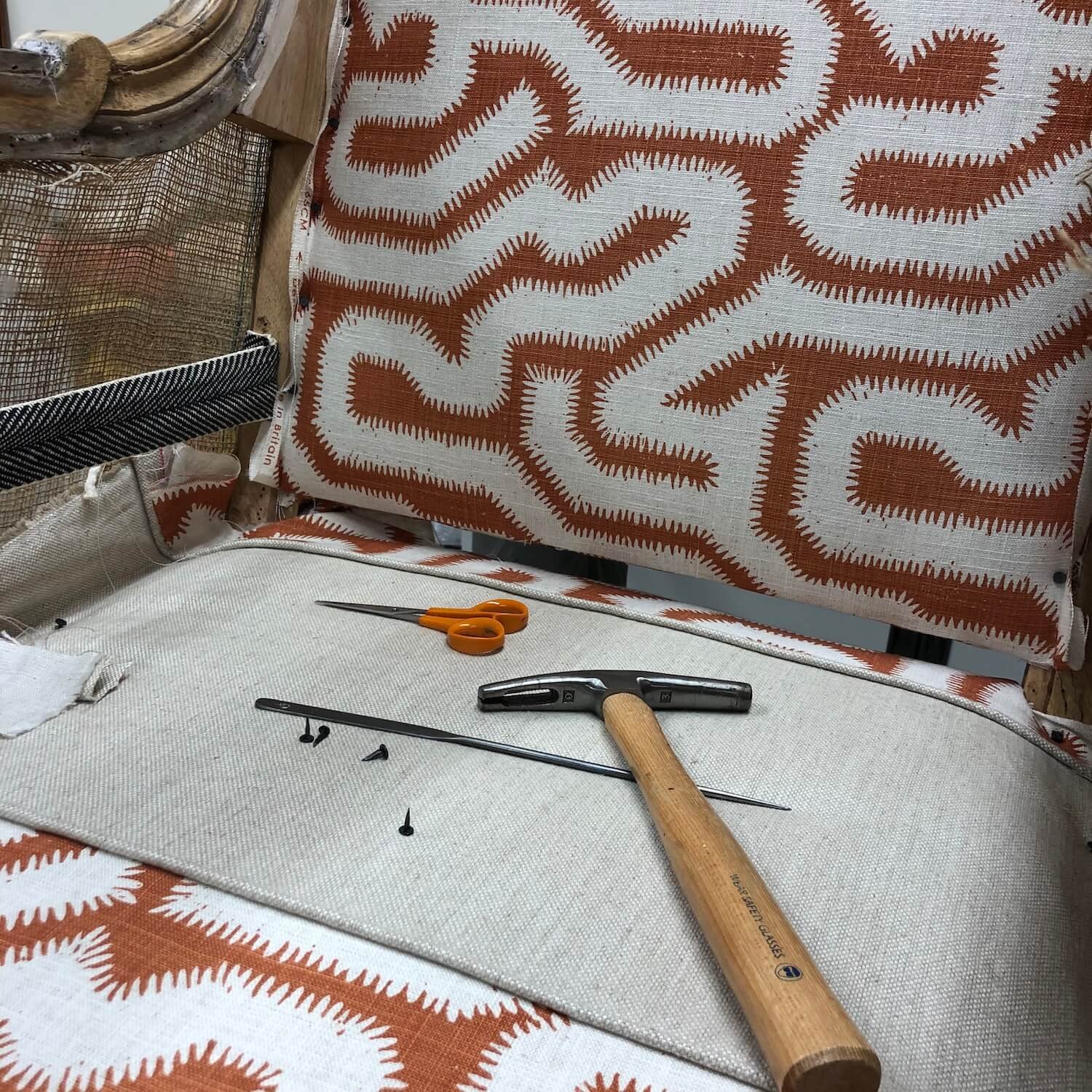 Hand-stitched webbing and hessian during traditional upholstery process