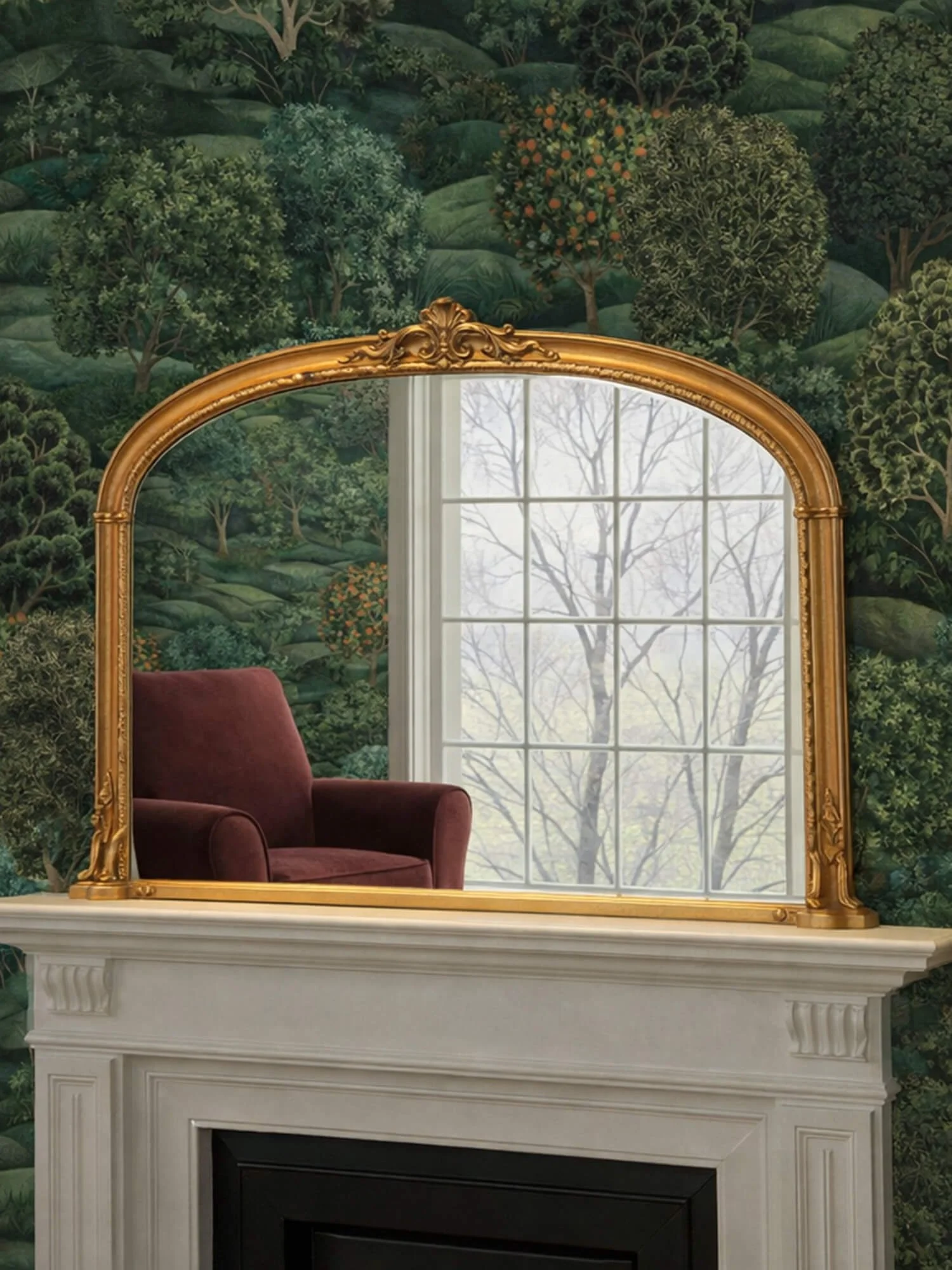 Ornate arched overmantel mirror by Yearn Mirrors London in gold