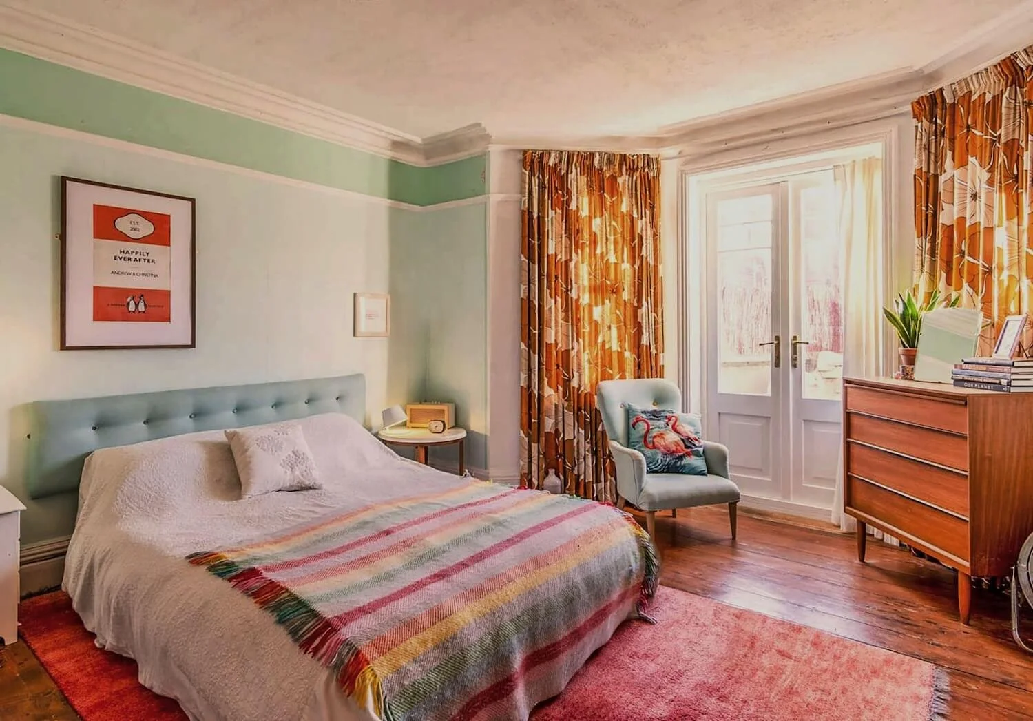 Vintage-inspired bedroom with patterned curtains, pastel walls and wooden furniture