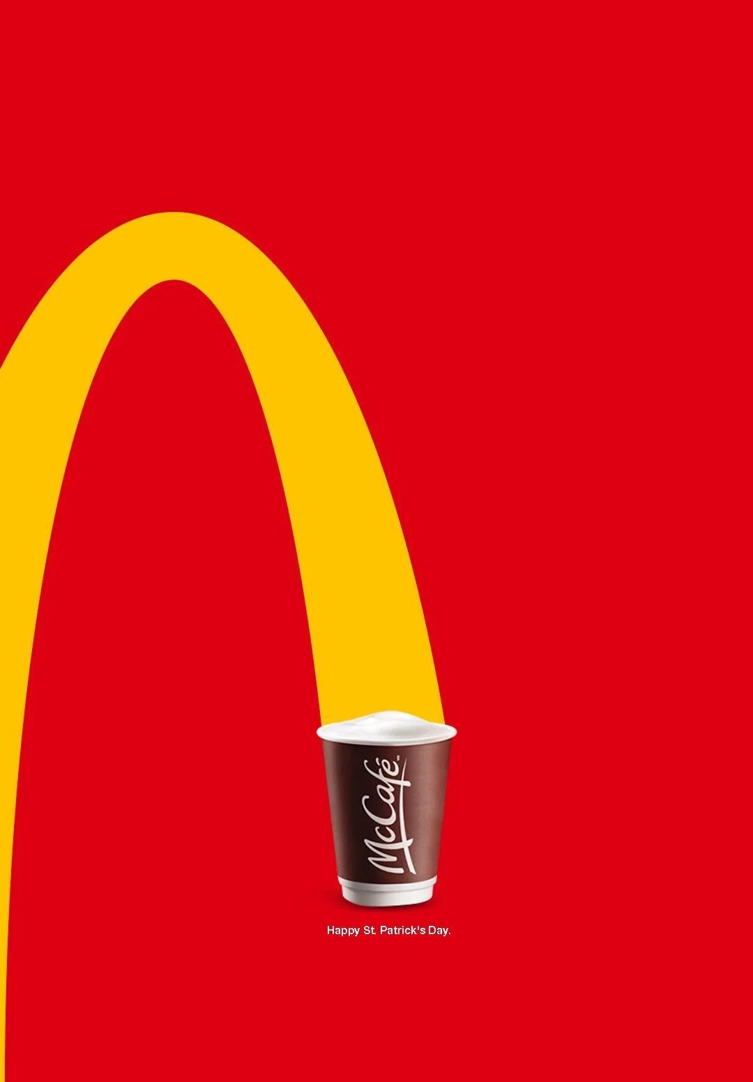 McDonald's logo with a coffee cup in the foreground and a red background with a yellow arch and the text 'Happy St Patrick's Day'.