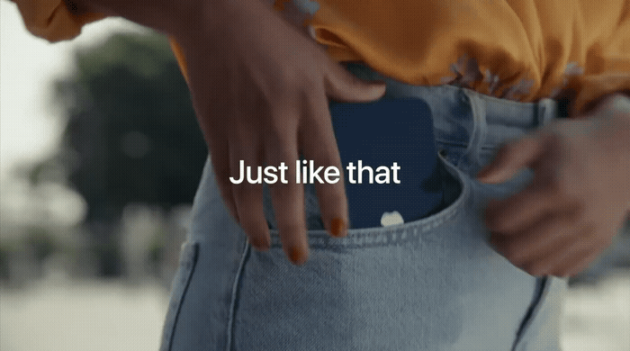 Close-up of a person placing their hand into a blue jeans pocket, with the text "Just like that" overlaid on the image.