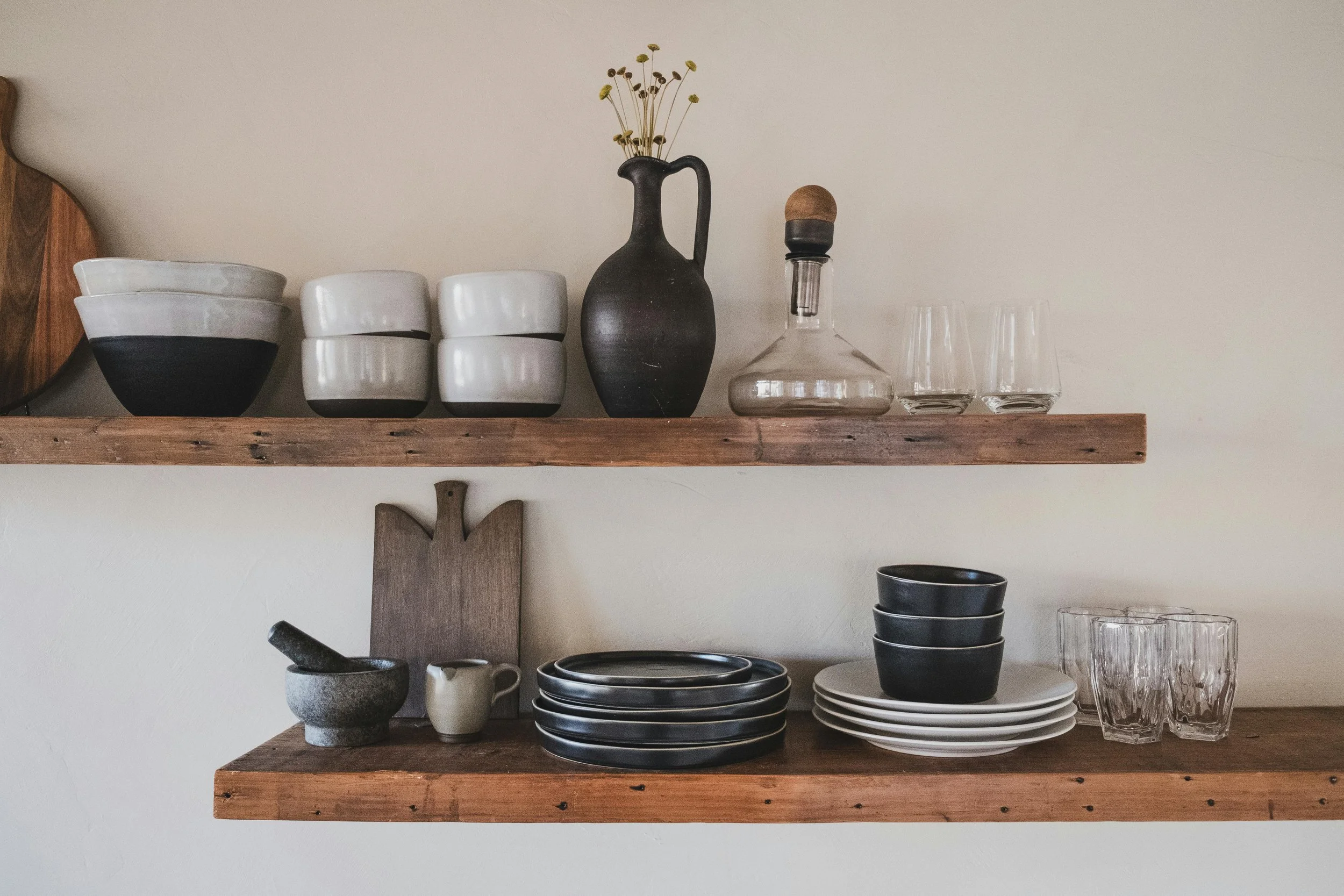 modern neutral kitchen countertop with glass canisters, wood utensils, and ceramic storage jars in soft natural light #KitchenOrganization #HomeStyle