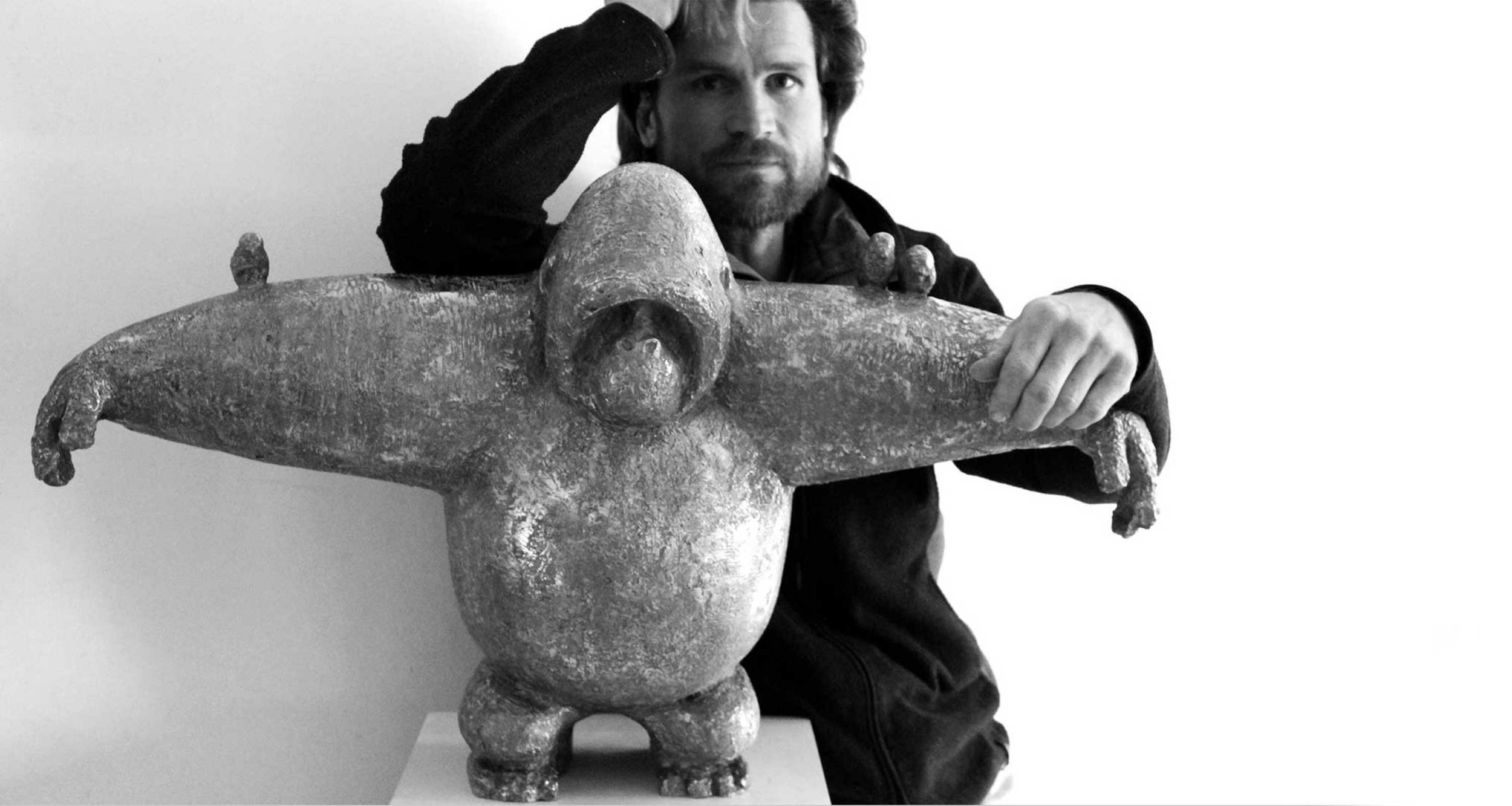 Samuel Allerton, famous South African Sculpture whose bronze sculptures of the gorilla from The Democratic republic Congo are endangered, celebrated in his soul series, here he stands with The Protector a large-scale bronze sculpture