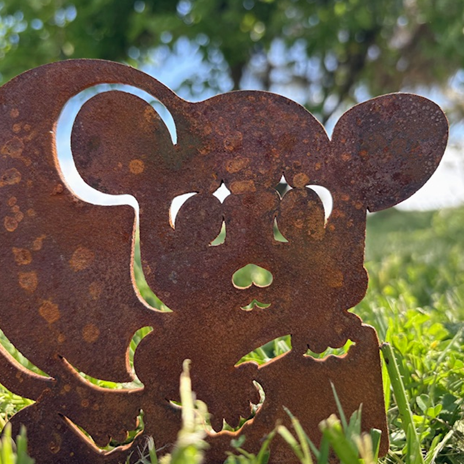 Close-up of a rusted metal sculpture featuring cute Aussie native possum.