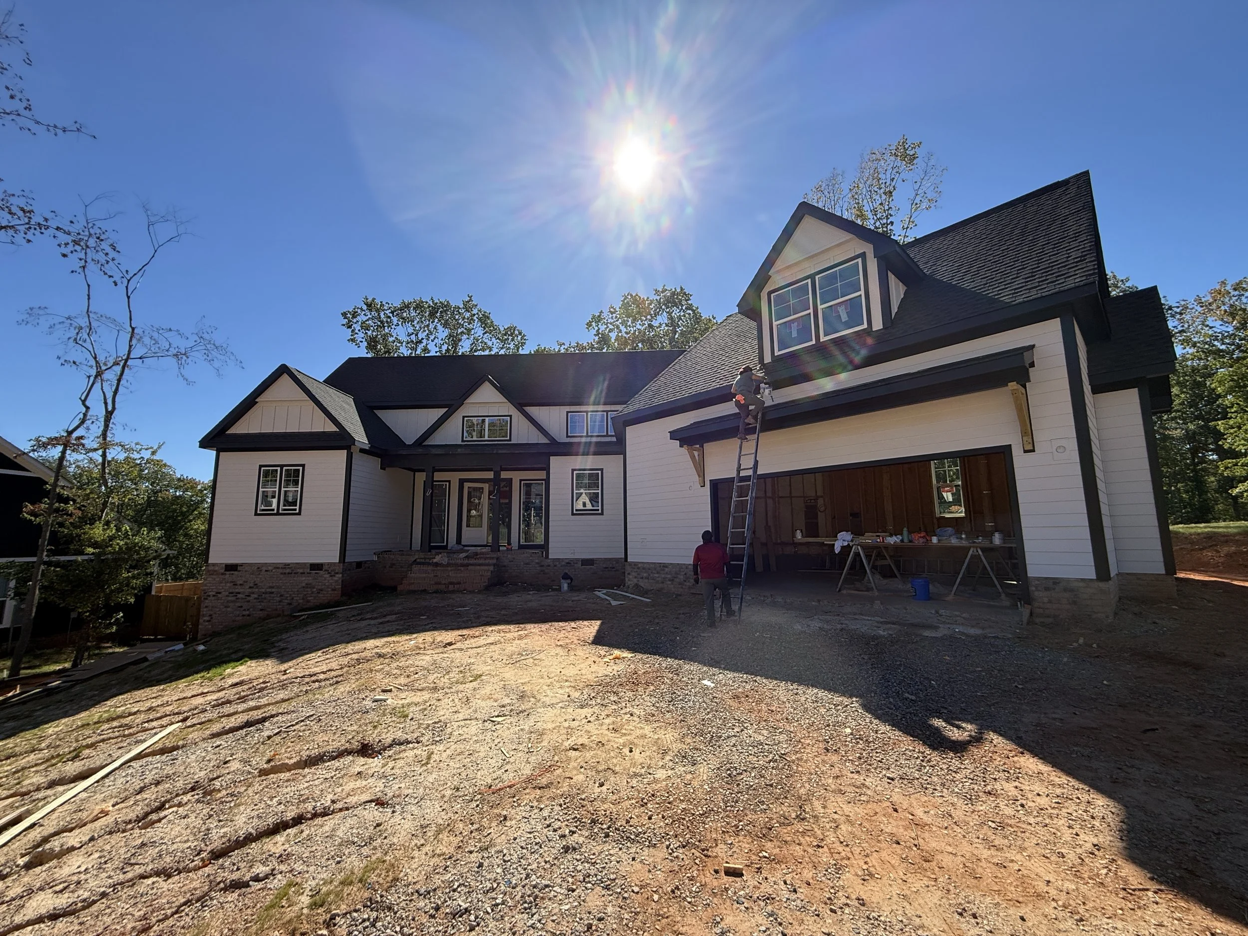 black shingle and metal roof on new construction house