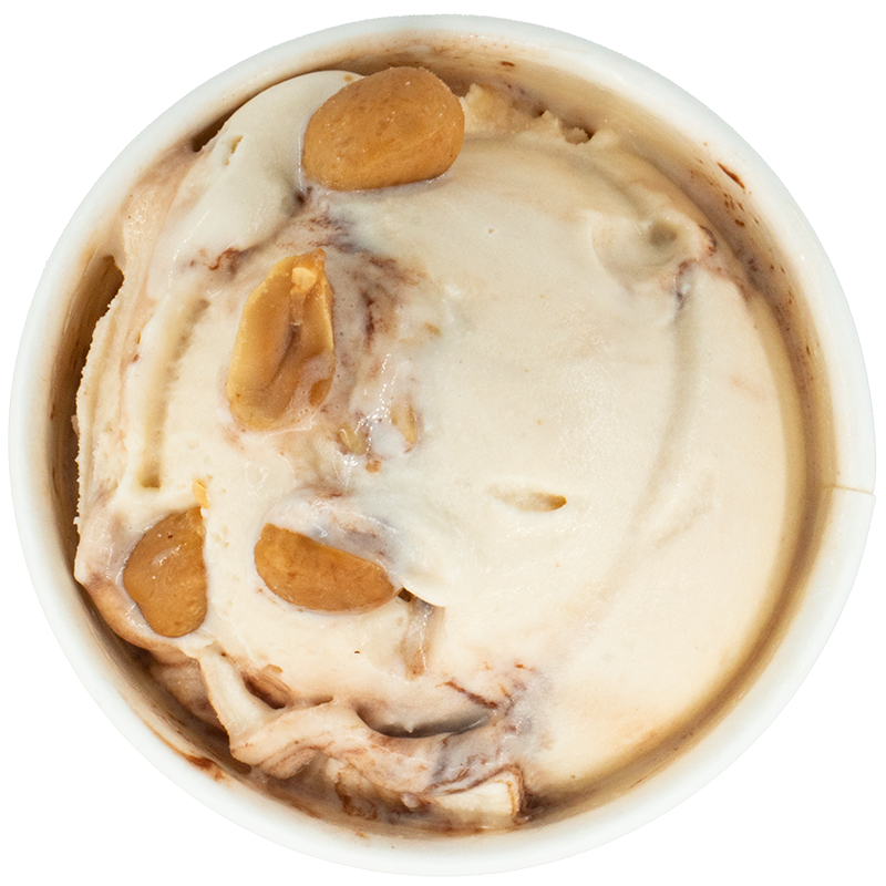 A cup of ice cream with swirls of caramel and chunks of salted caramel candies.