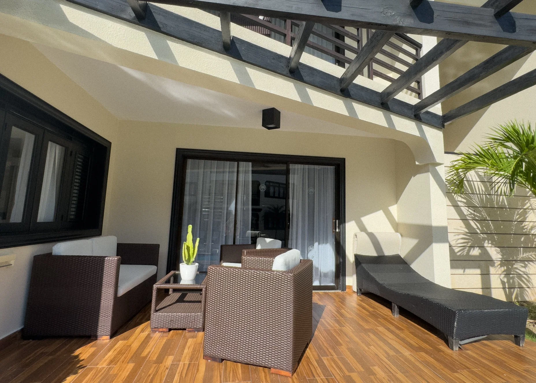 Elegant balcony with wooden floors and premium seating area for relaxation.