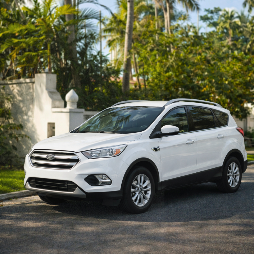 A sleek white luxury car parked in front of a stone wall entrance.