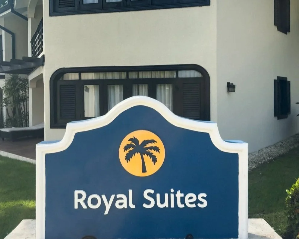Official Royal Suites signage with palm tree logo.