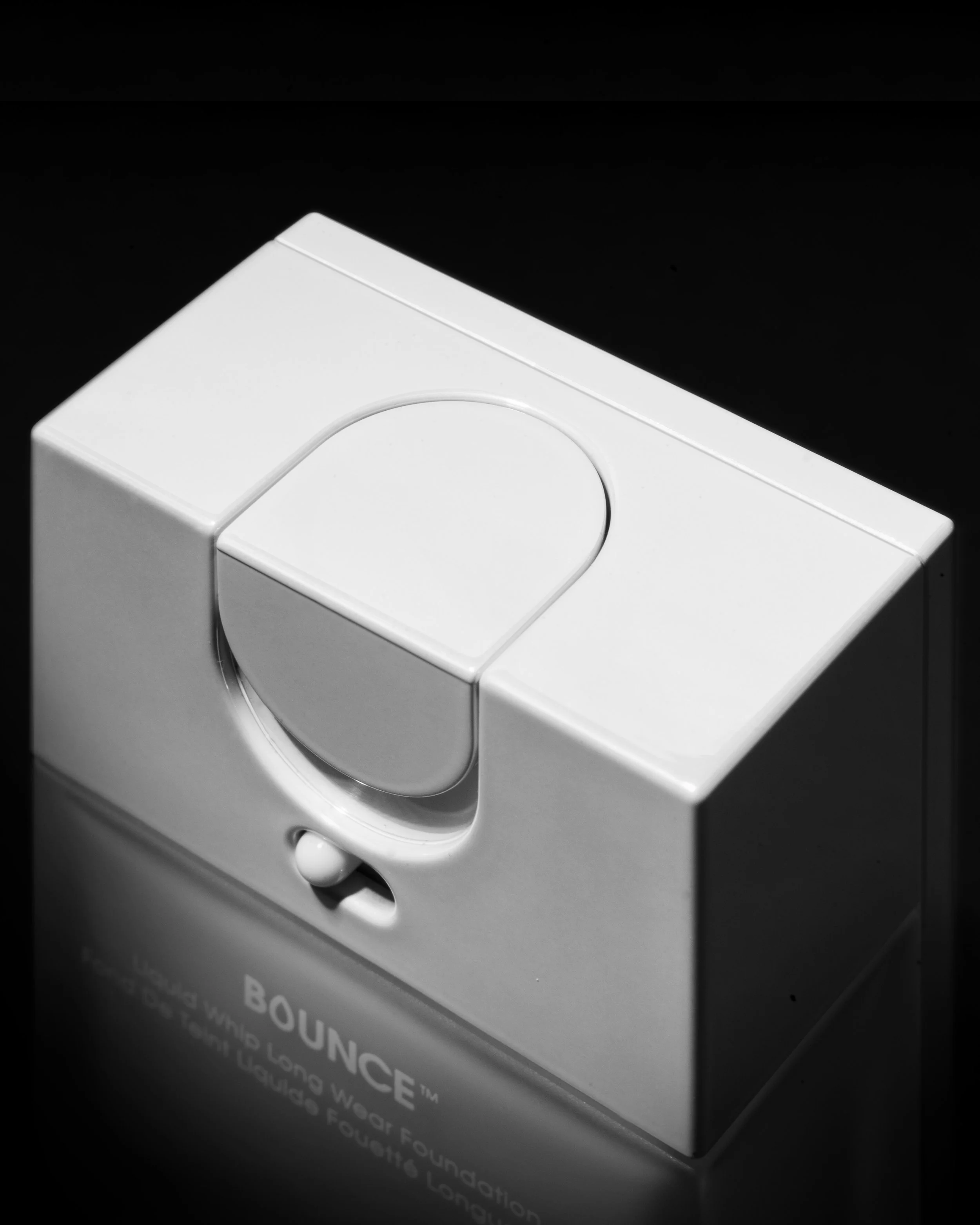 A white compact makeup product called BOUNCE from the LANE WARD Foundation line, placed against a black background.
