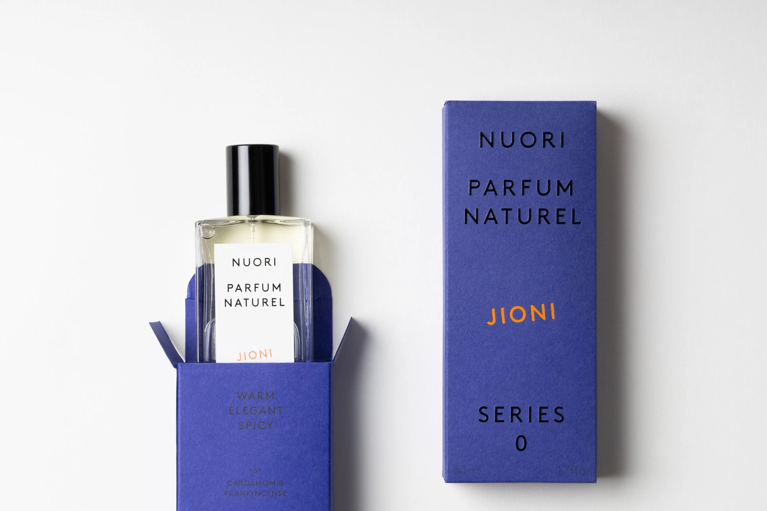 A bottle of NUORI Parfum Naturel fragrance in a blue box, with additional details visible on the packaging, placed on a white background.
