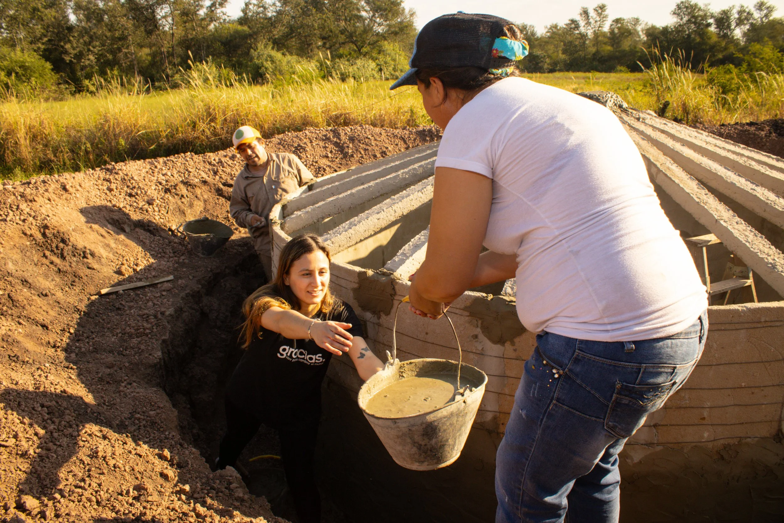  The family participates in the construction process as the new cistern nears completion. 