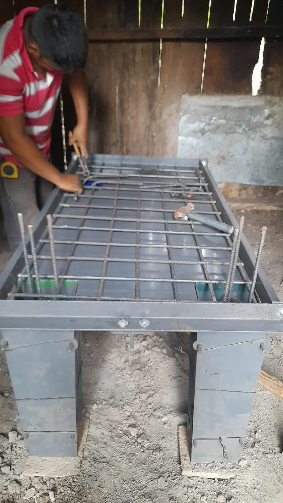  Local workers preparing the form for the new cement stove to be installed in one of the homes. 