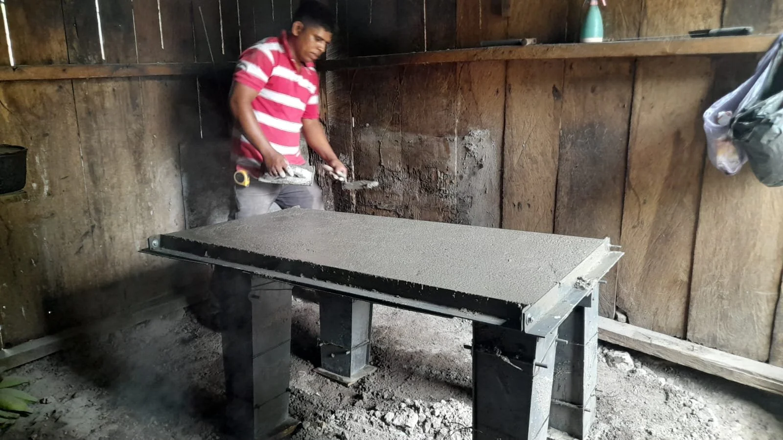  The stove form takes shape with fresh cement. Once dry, the form will be removed and the finished stove will be prepared for use. 
