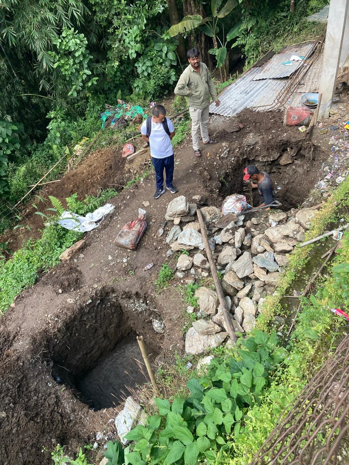  New holes are dug to prepare for the footings of the new foundation. 