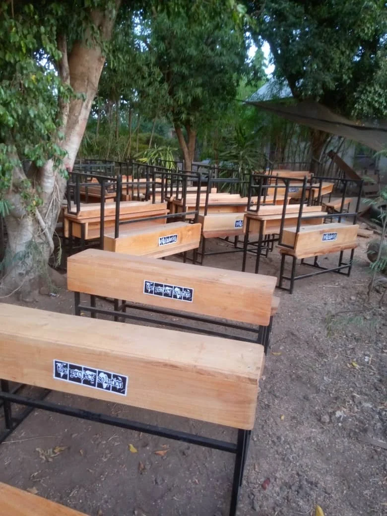  New desks with The Project Solution logo are ready to go into the classroom. 