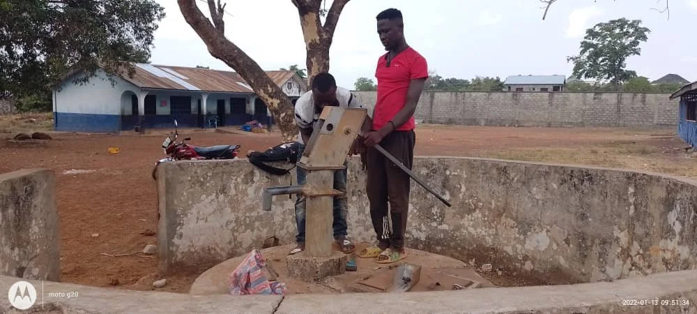  Workers evaluating the broken pump and beginning repairs. 