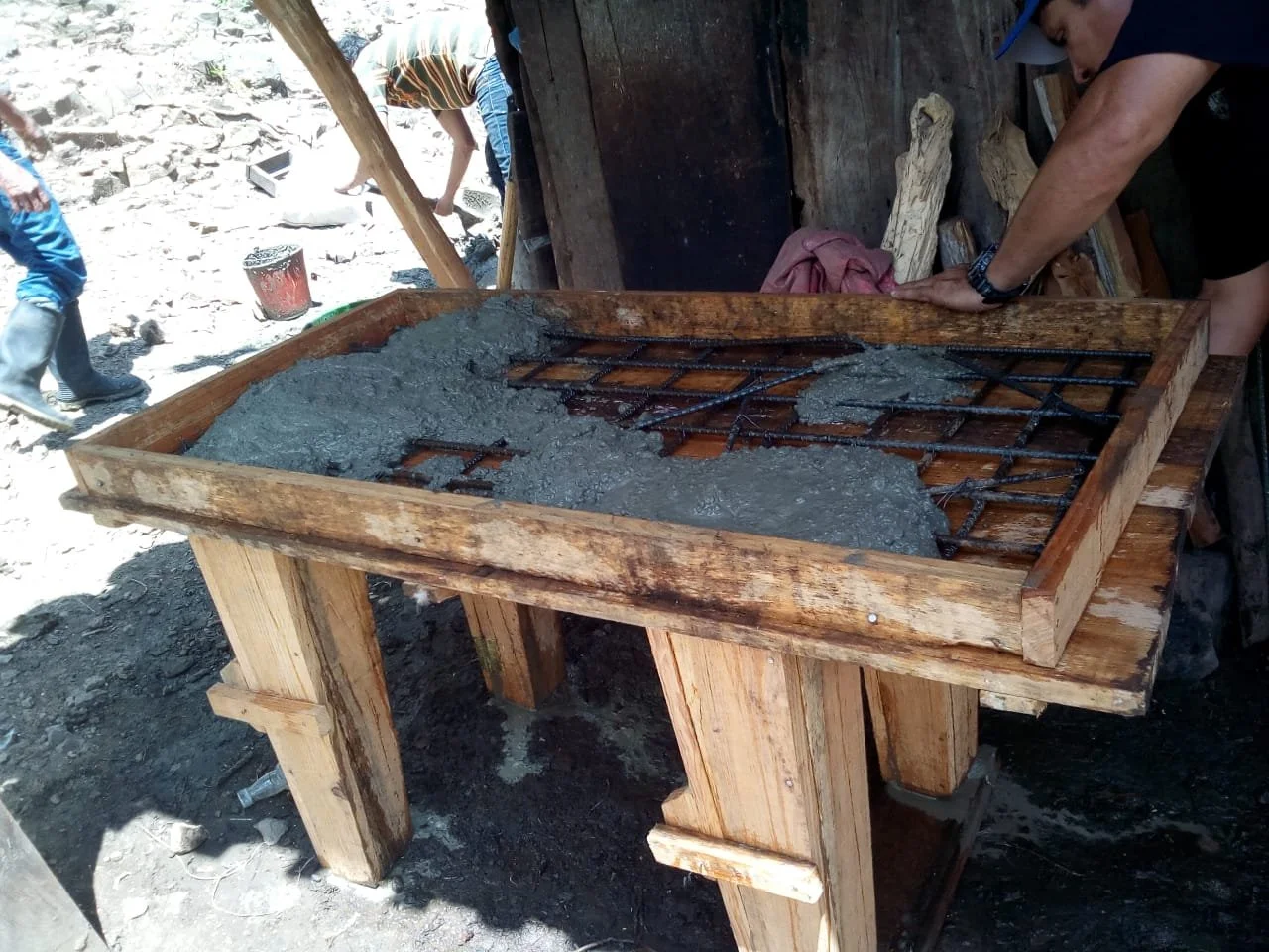  Wood forms are used along with metal rebar to provide structure to the fresh concrete pour that will ultimately create the finished stove structure. 