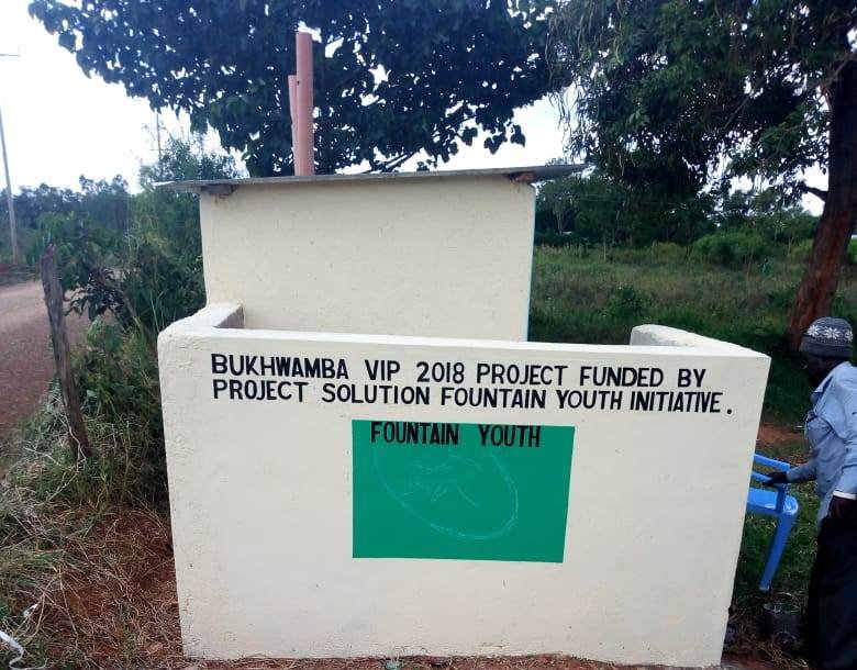  A hand washing station is on the side of the toilet facility with a thank you note to us and the local organization we collaborated with, Fountain Youth Initiative. 