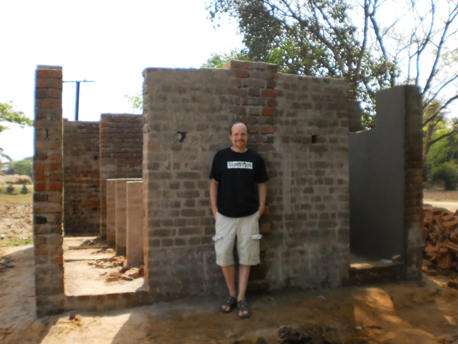  Here I am not long before my departure from Orissa. The building height is complete and you’ll notice some nice smooth finish plaster work inside on the right side. A roof will be added and everything will be painted. Looking forward to seeing the f