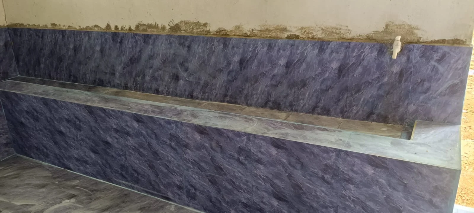  A urinal with the finished tiles. 