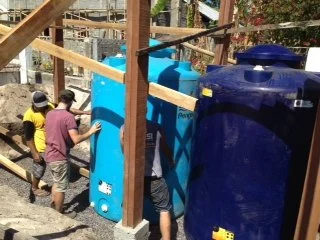  Local team members are working at the Siladen Elementary School to help install new rainwater cistern tanks. 