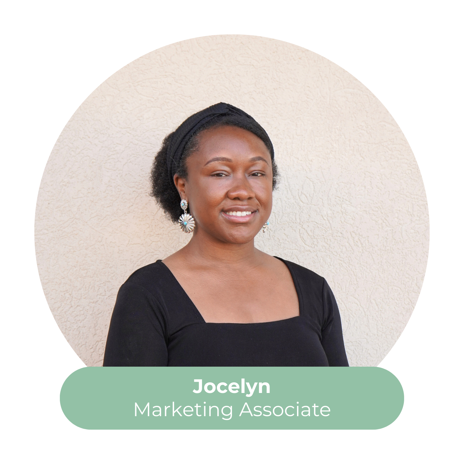 Portrait of Jocelyn, a marketing associate, with dark hair in a bun, wearing black top and silver earrings, smiling against a neutral background.