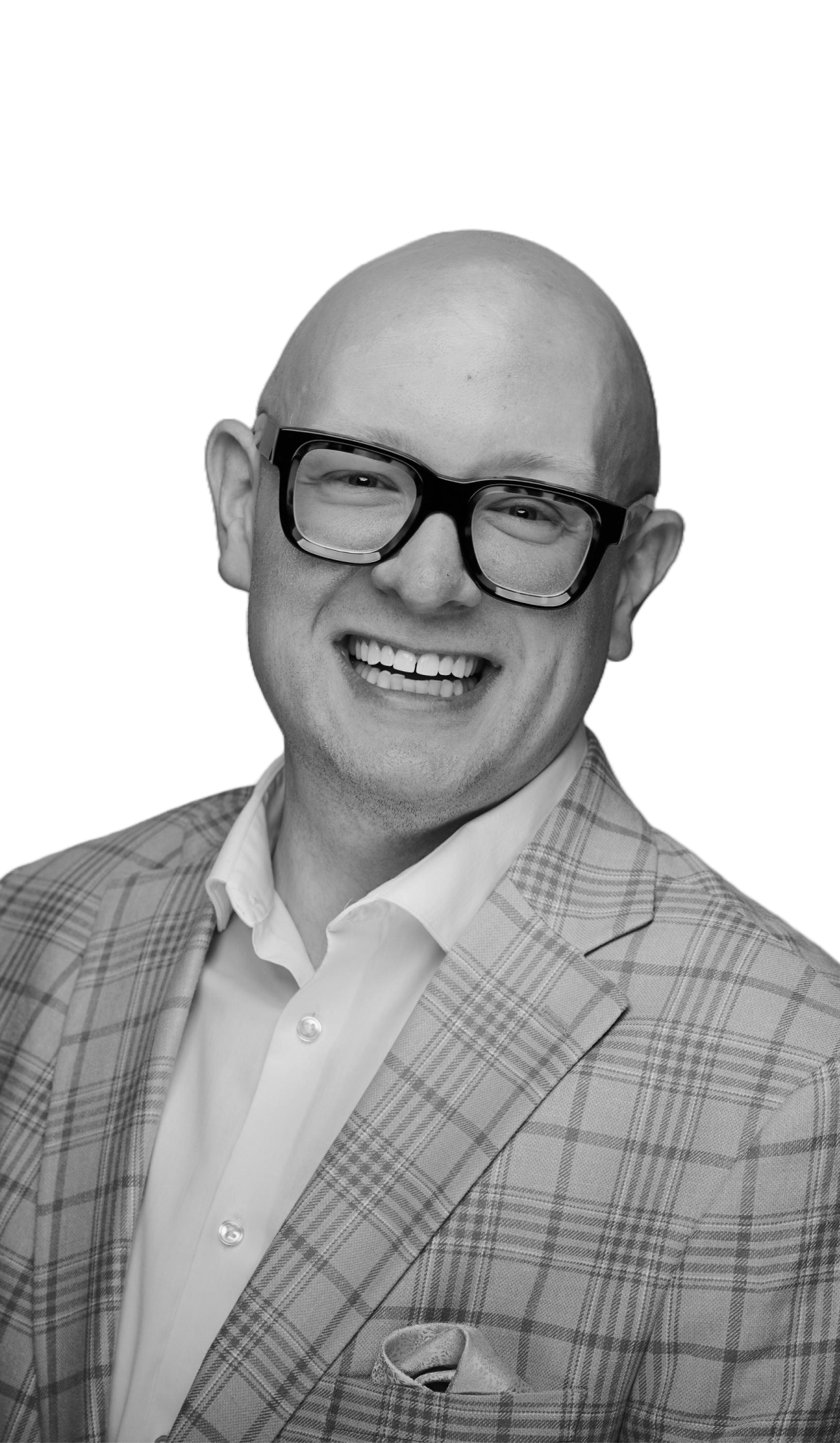 A smiling man wearing a plaid suit jacket, white shirt, large black glasses, and a pocket square.