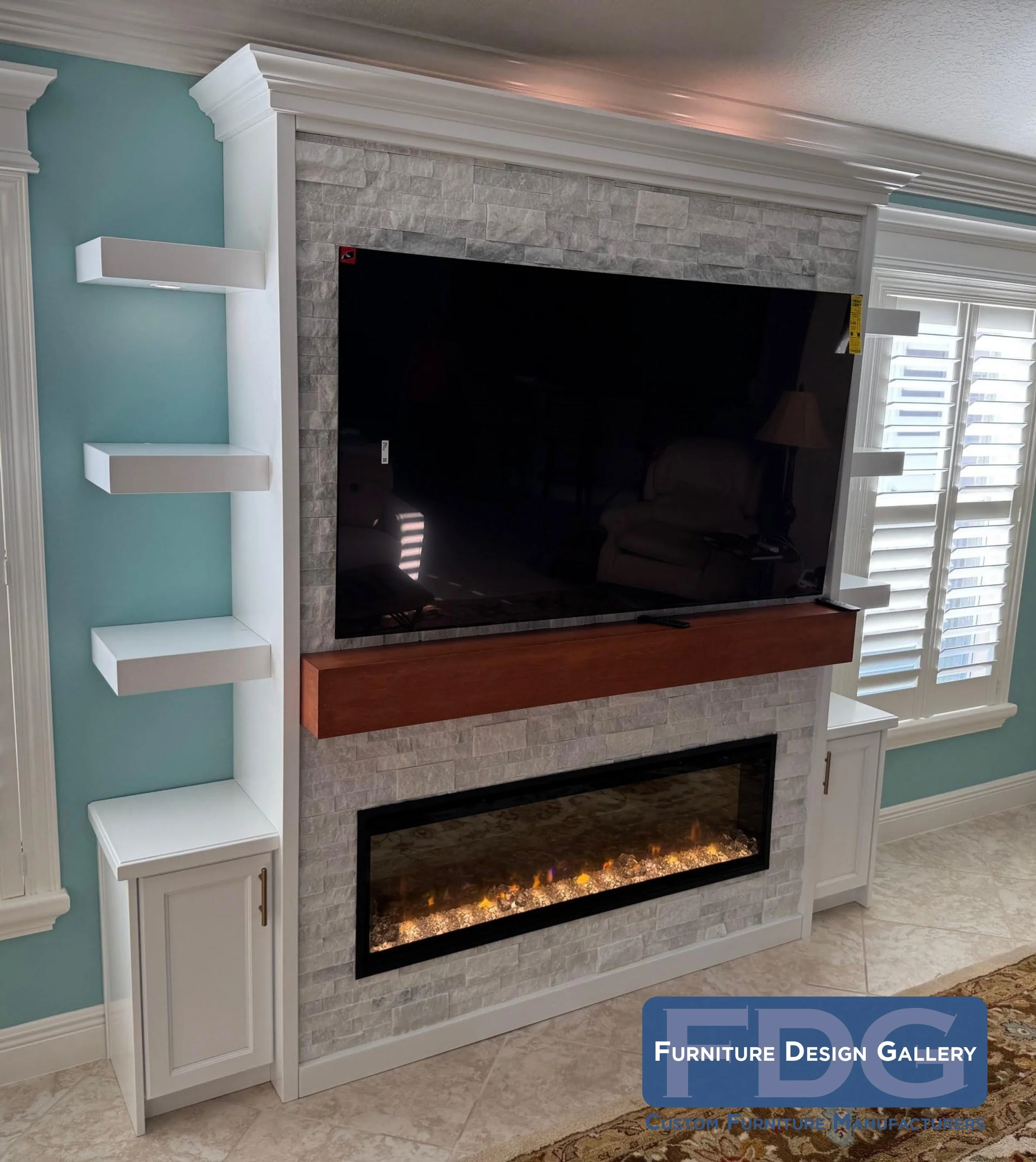 30. Elevate your living space with this sophisticated custom wall unit, featuring clean white floating shelves, a natural stone fireplace surround, and a warm wood mantel for the perfect blend of modern and cozy.