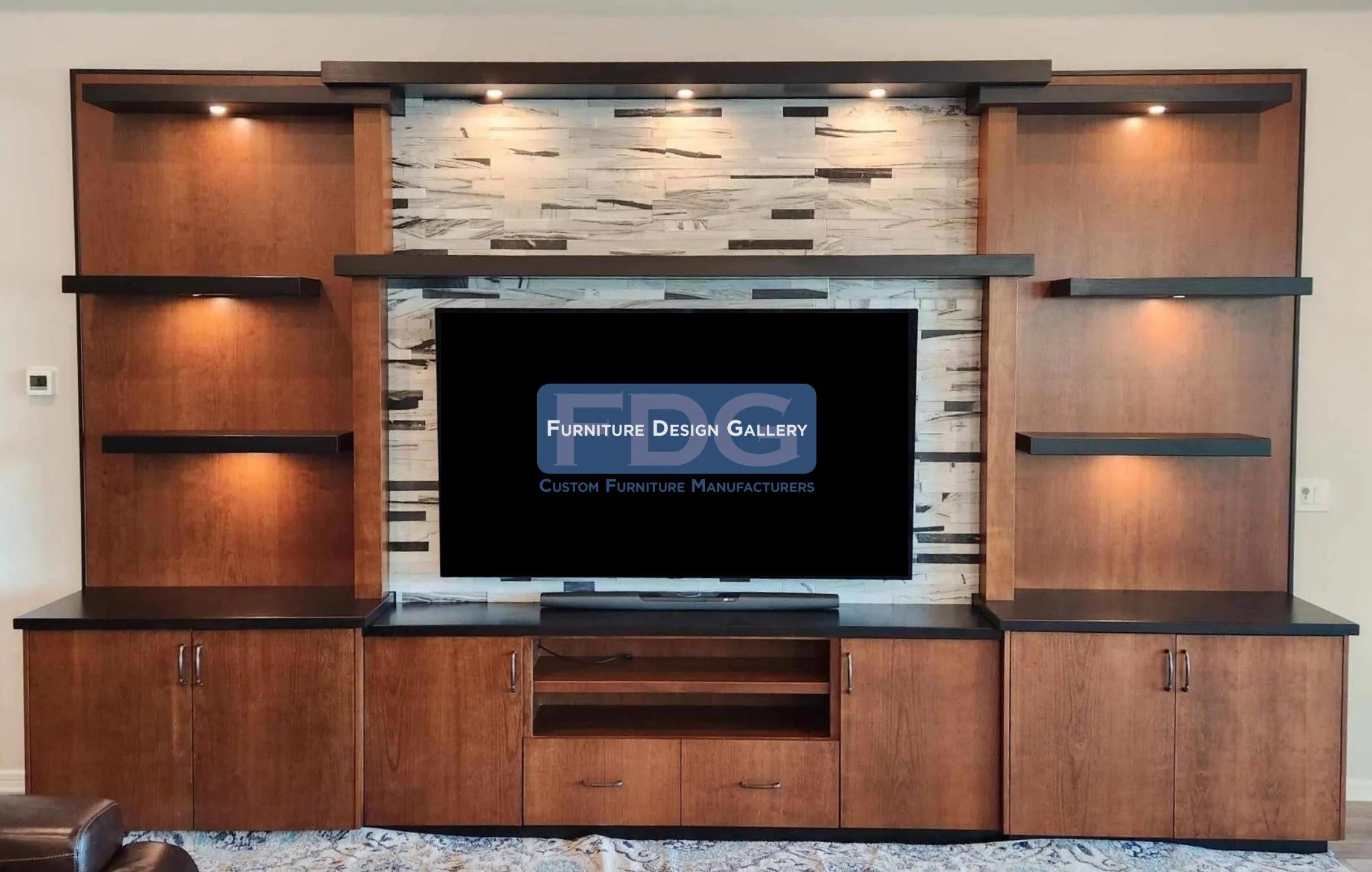 43. Architectural and striking. This custom cherry wood wall unit features a stunning ledger stone backdrop, floating black shelves with integrated puck lighting, and ample cabinetry for a perfect mix of display and storage.