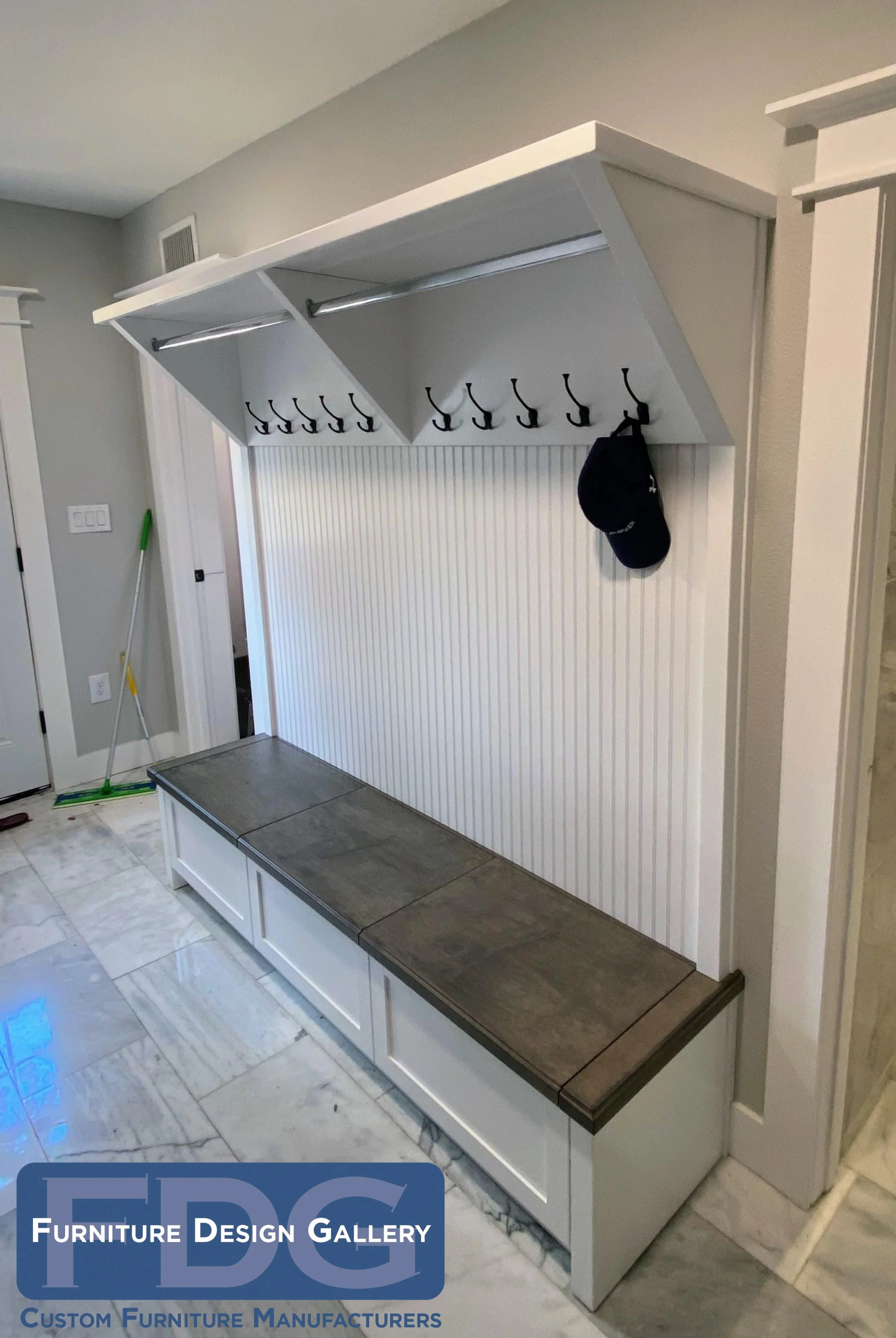 1. Ultimate entry organization. 🧥👢 This custom mudroom bench combines beadboard texture with functional hanging rods and a contrasting wood seat for an elegant drop zone.