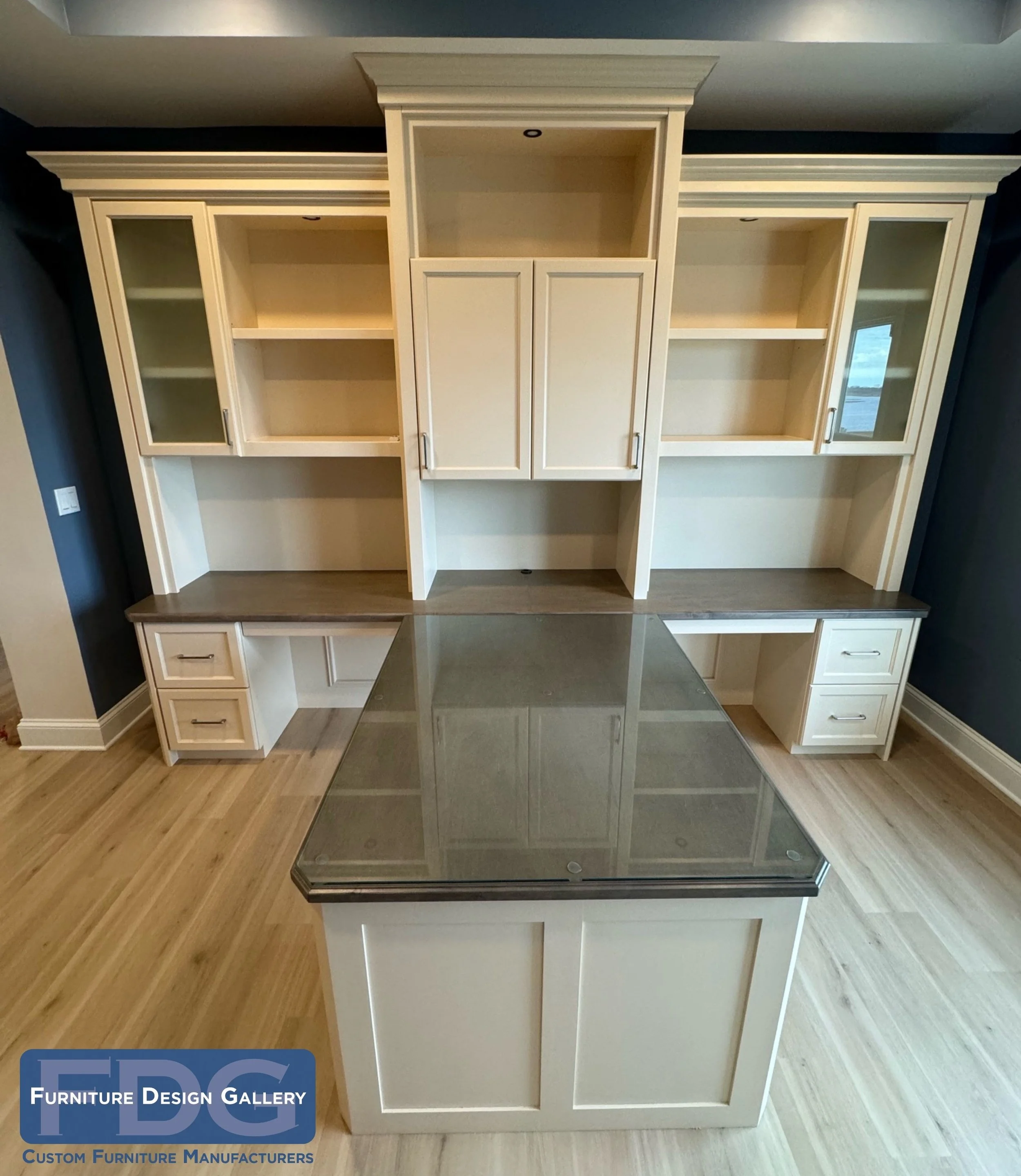 26.  The ultimate shared workspace. We paired cream cabinetry with a contrasting stained wood desktop to create a highly functional, double-sided partner's desk with dedicated work areas and shared overhead cabinets.