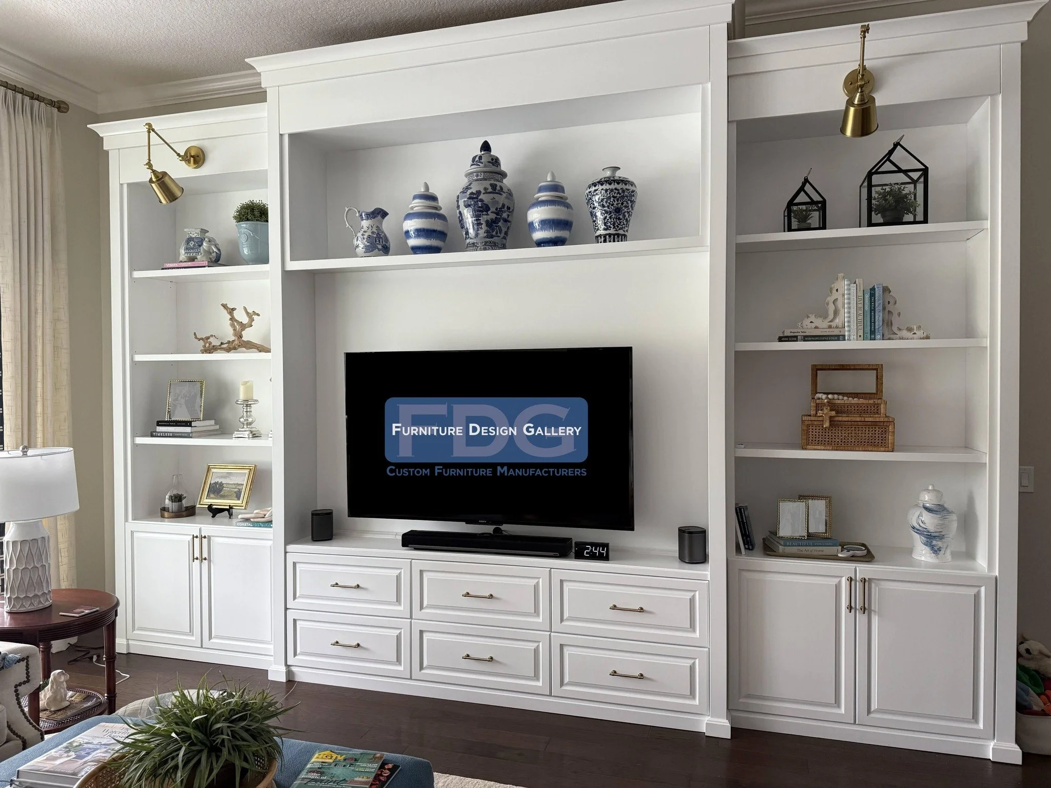 32. Modern elegance meets functional design. This custom built-in features clean white lines, brass accents, and a perfectly integrated entertainment hub.
