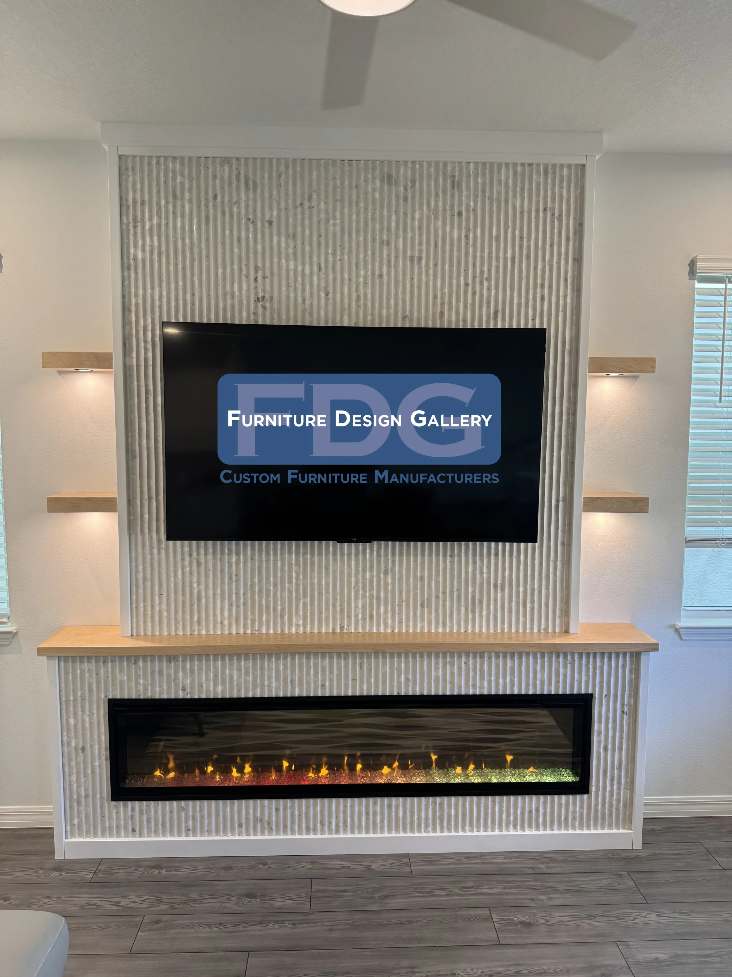 19. Modern texture meets cozy warmth. 🔥 This custom fireplace feature uses fluted paneling and floating shelves with integrated lighting to create a stunning, high-end focal point.