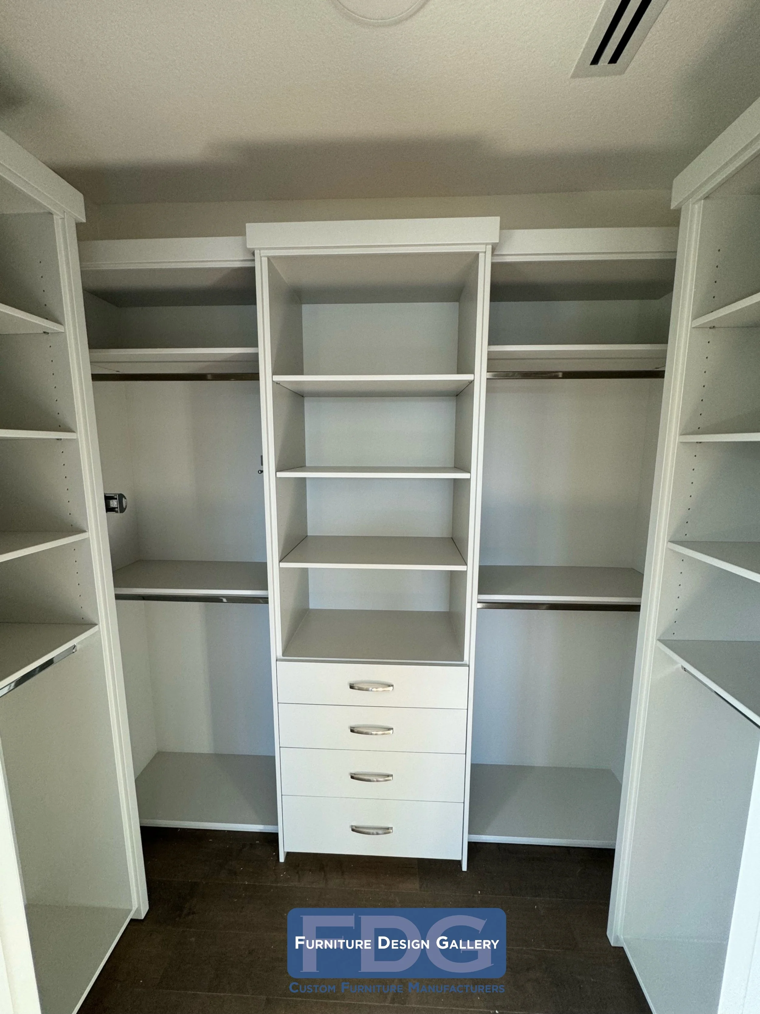 12. Symmetry meets storage: a masterfully organized walk-in featuring a central drawer tower and expansive hanging space.
