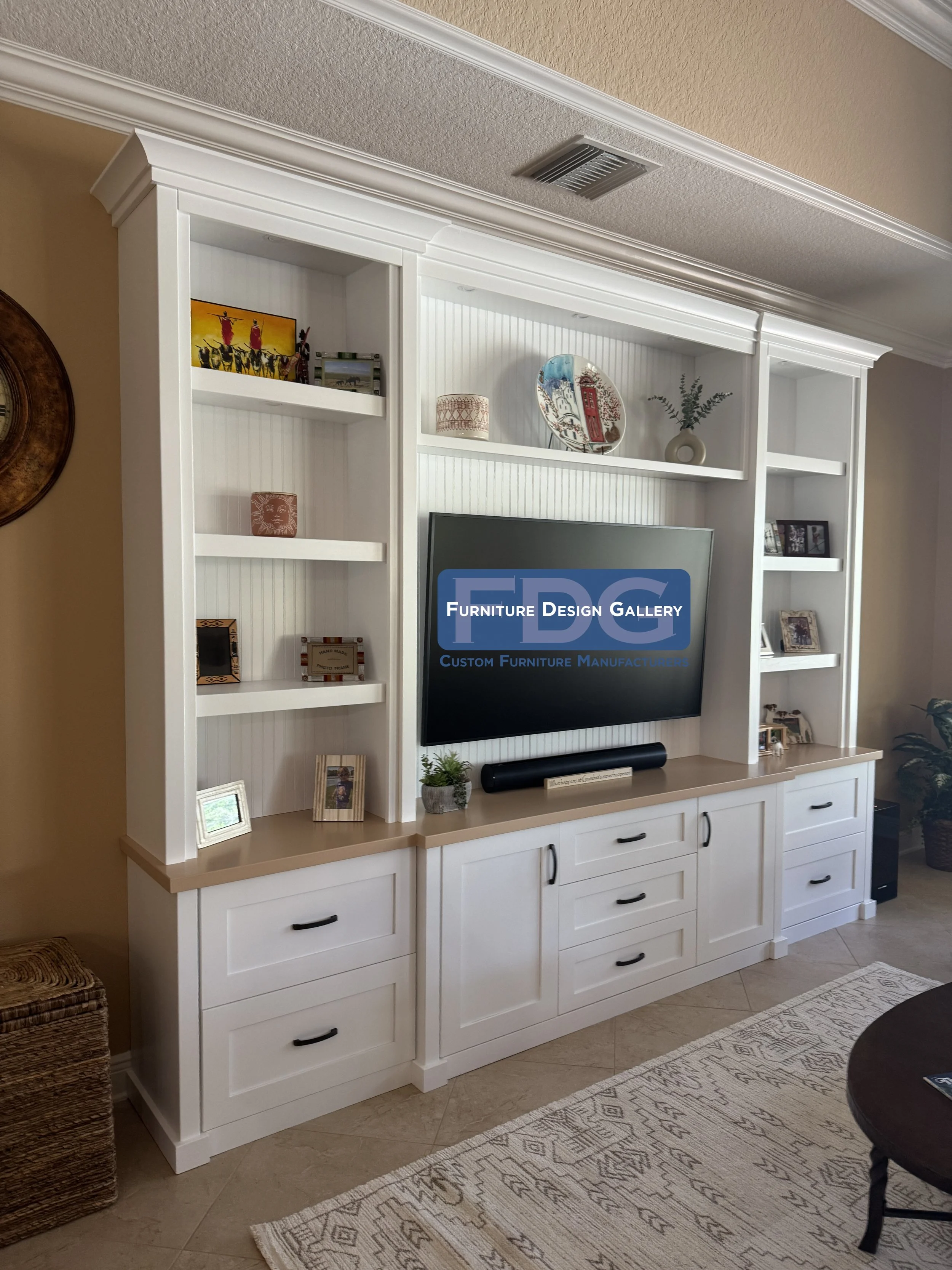 5. Modern farmhouse elegance. This custom wall unit features a classic beadboard backing and a warm wood-toned countertop, perfectly blending cozy textures with plenty of storage for a timeless living room look.