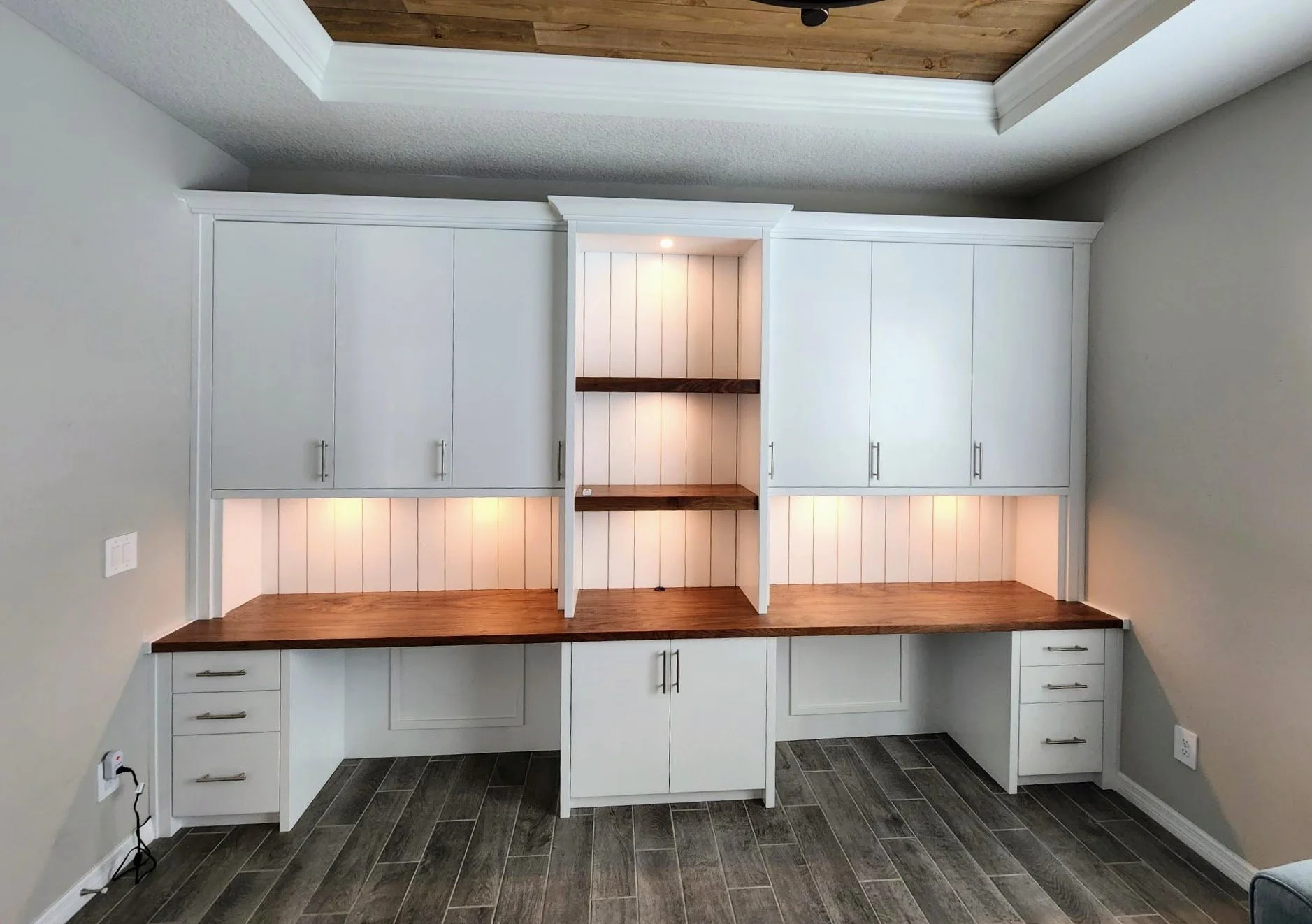 17. Whether you’re looking for a professional home office or a creative hub for two, this custom built-in delivers. The perfect blend of bright cabinetry and warm wood tones creates a workspace that is as functional as it is beautiful.