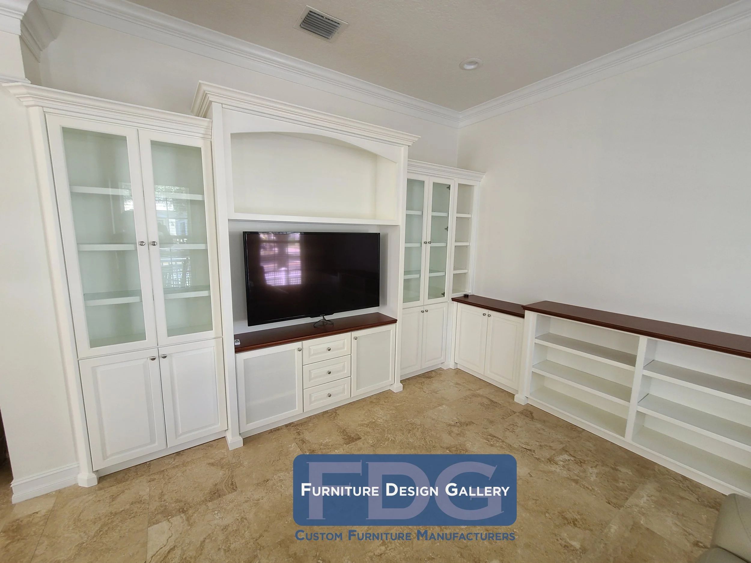 35. Timeless sophistication: a grand custom wall unit featuring elegant glass-front cabinetry and warm wood-top accents.